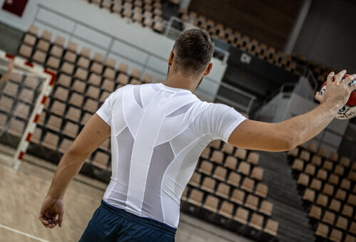 Man in a posture shirt playing handball